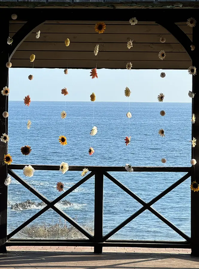 A seaside wedding installation framed against the ocean
